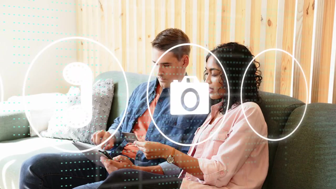 Man tapping tablet while woman pointing, animated UI icons flowing over them for tech sharing