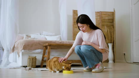 woman feeding cat