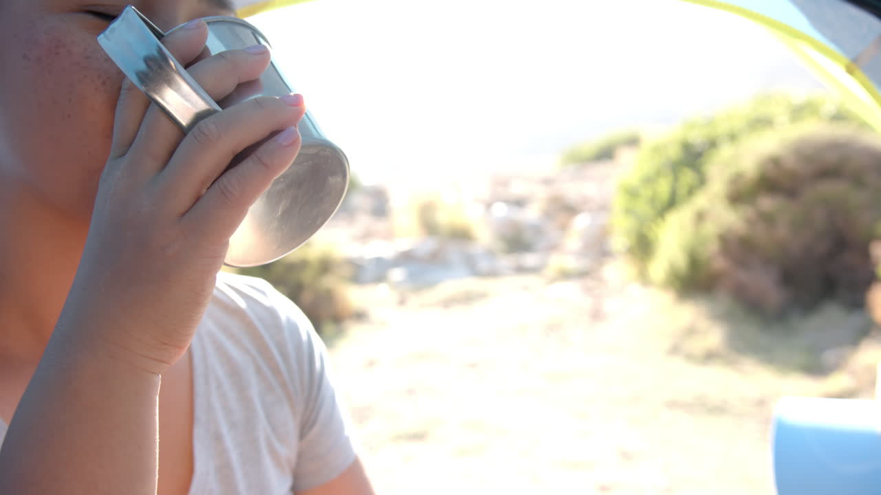 Hydrating during mountain hike, woman drinking water from bottle, copy space