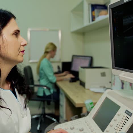 medical specialist works with ultrasound apparatus. professional woman doctor explaining results while doing ultrasound research in clinic.