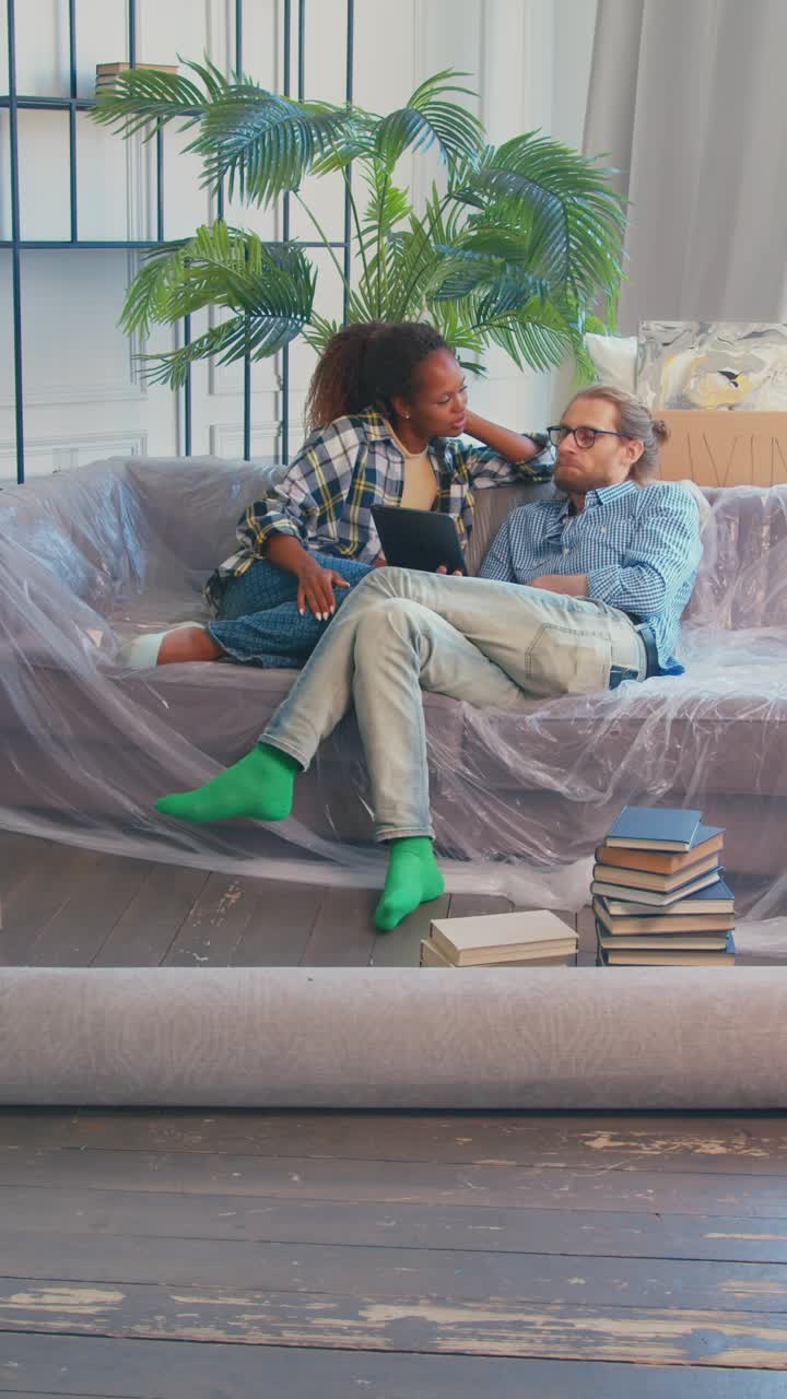 Couple discussing ideas in a cozy living room during home renovation