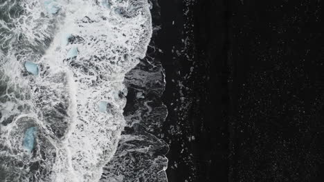 Stunning-drone-shot-of-surf-with-ice-rocks-at-Diamond-Beach-in-Iceland