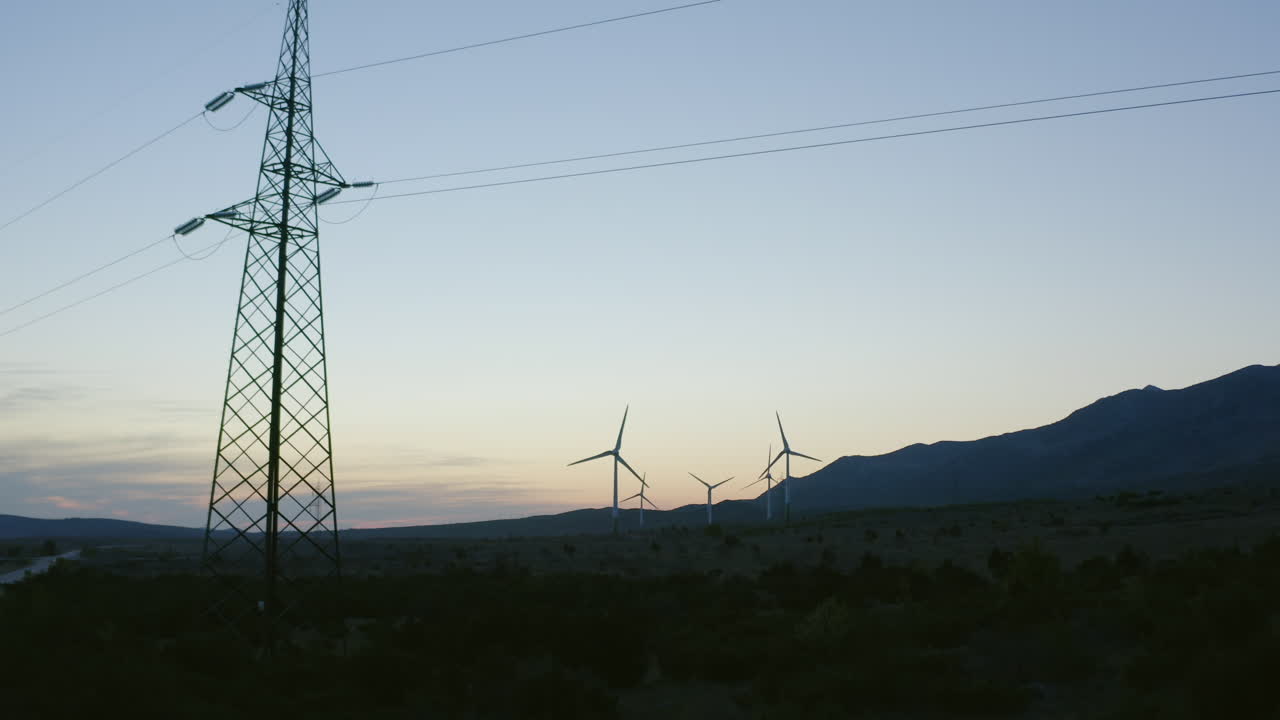 Wind Turbines and Power Lines at Sunset