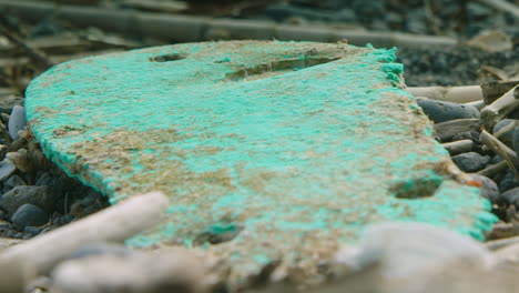 Close-up-shallow-focus-shot-of-a-flip-flop-and-other-washed-up-plastic-on-the-beach