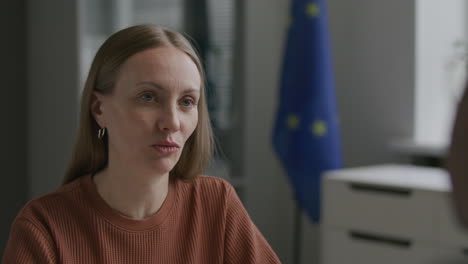 woman being interviewed for schengen visa at eu embassy