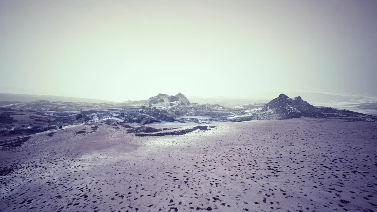 Snowy landscape reveals majestic mountains under a cloudy sky at twilight