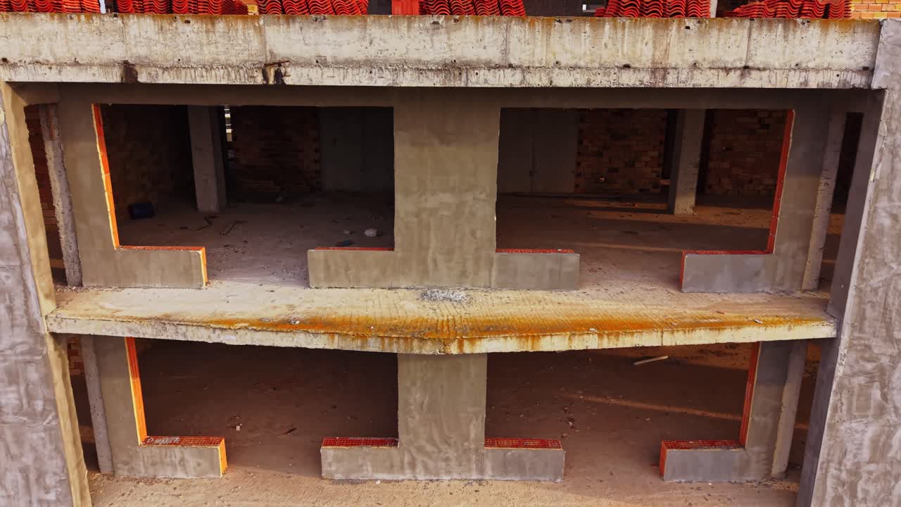 View of unfinished concrete building structure from above during daytime