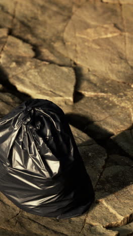 black garbage bag on the ground