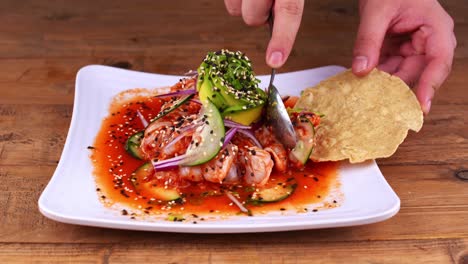 closeup of aguachile dish being served on a corn tostada