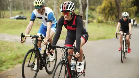 group of focused athletes riding bikes