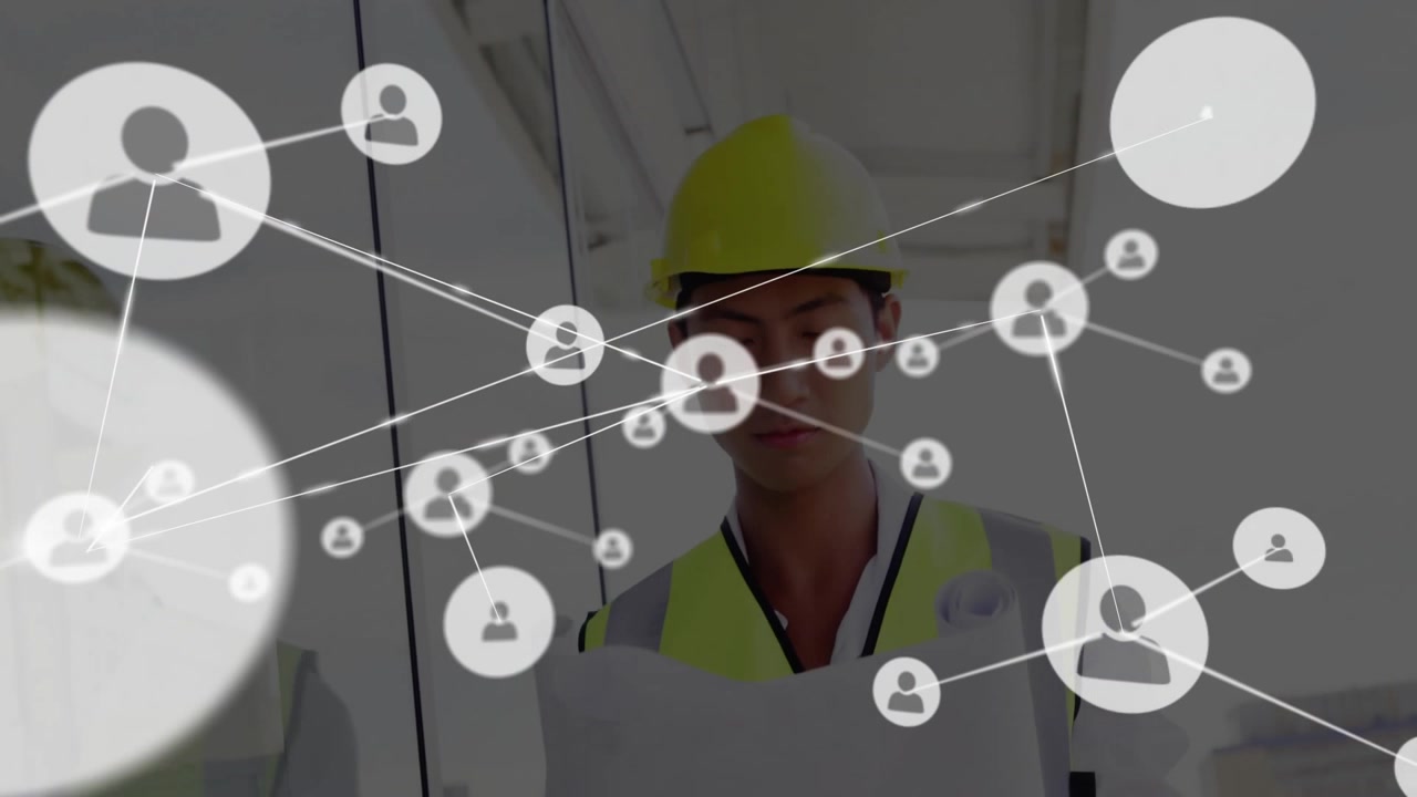 Construction Engineer Reviewing Blueprints with Digital Network Overlay
