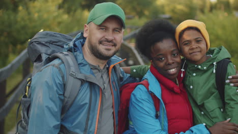 portrait of happy multiethnic family on hike in national park