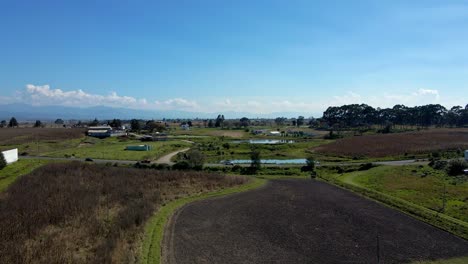 bird's eye view over vast fields of farms, field rooted by fire on a sunny day, drought