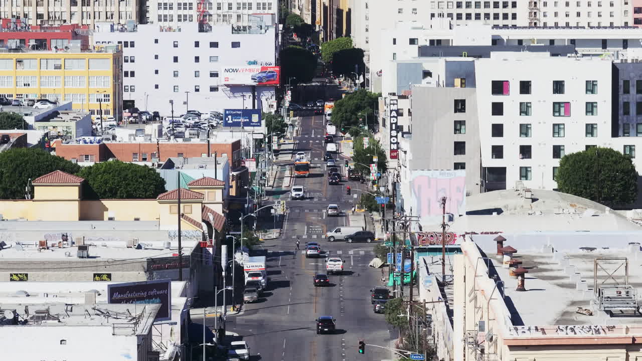 Overhead view of a bustling Los Angeles city street with buildings and cars