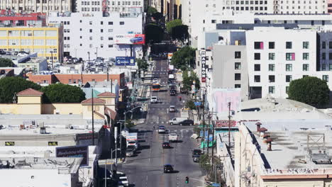 overhead view of a bustling los angeles city street with buildings and cars