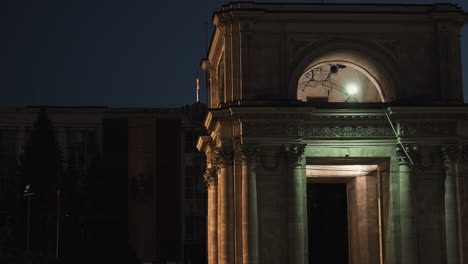 the triumphal arch in chișinău, moldova beautifully lit at night. a historic landmark glowing in the city center during nighttime hours.