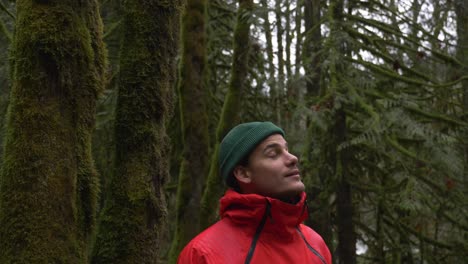 Young-Man-Enjoying-the-Outdoors,-Looking-Around-in-Lush-Forest-SLOMO