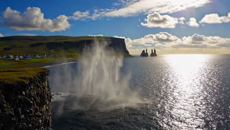 dramatic icelandic coastline: reynisdrangar sea stacks and ocean blowhole