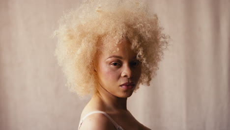 studio portrait shot of confident natural albino woman in underwear promoting body positivity