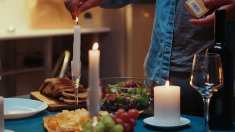 Close-up-of-man-lighting-the-candle