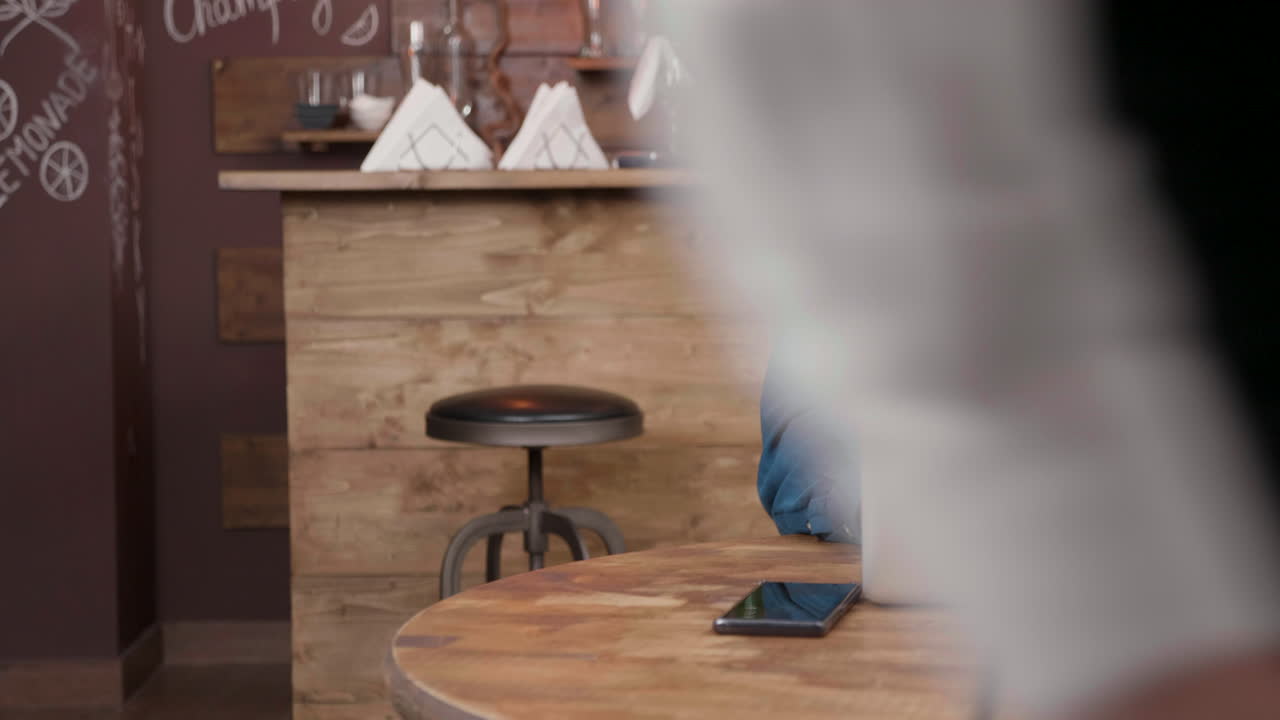 Man on a phone call working at cafe