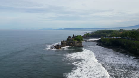 tanah lot temple with crashing waves slow track inwards bali indonesia