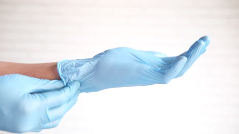 putting on blue latex gloves