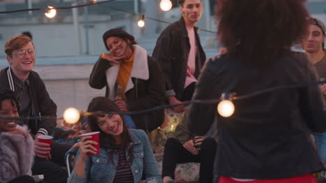 multiracial group of friends posing for photo on rooftop party at sunset students enjoying weekend gathering in urban city