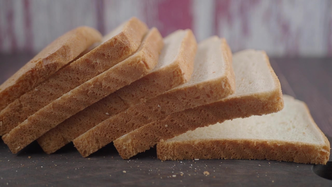 Stack of Fresh Sliced White Bread on a Wooden Board