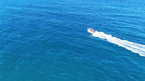 a speedboat travels swiftly across blue waters