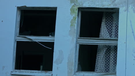 Mysterious-haunted-mansion-broken-window-close-up-shoot-at-evening