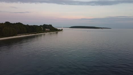 Drone-flys-over-beach-at-sunset