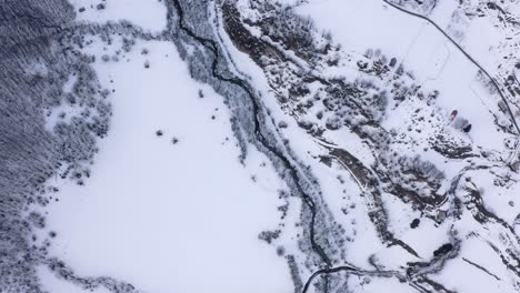 aerial - snowy winter in the mountains around kolasin, montenegro, circling top down