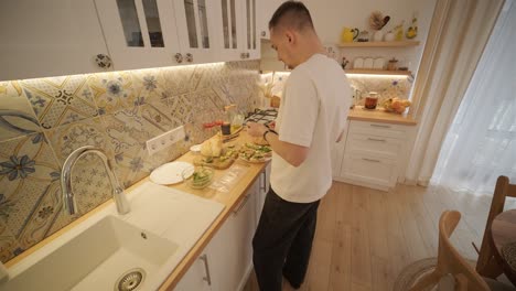 loving couple making a sandwich in kitchen-living room