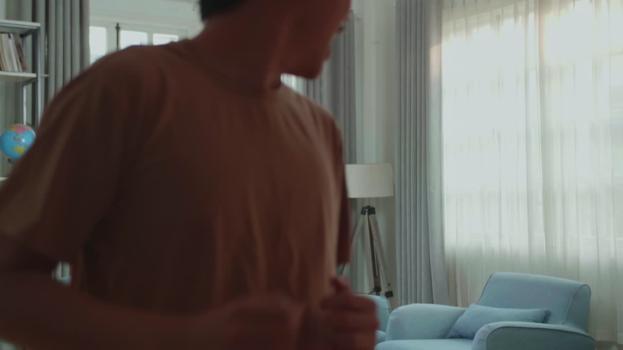 Asian Man Dancing While Shooting Video Content For Social Networks At Home