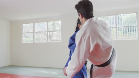 judokas training by doing a randori on the judo mat