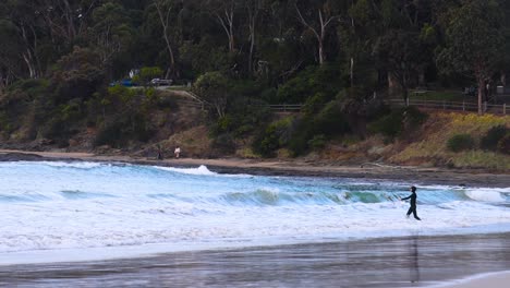 individual strolling by the sea in lorne