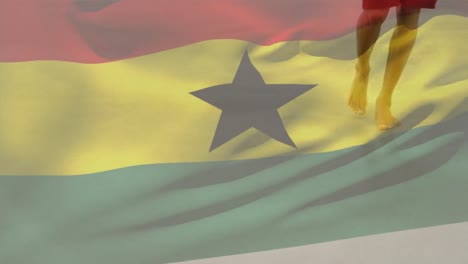 animation of flag of ghana over african american man at beach