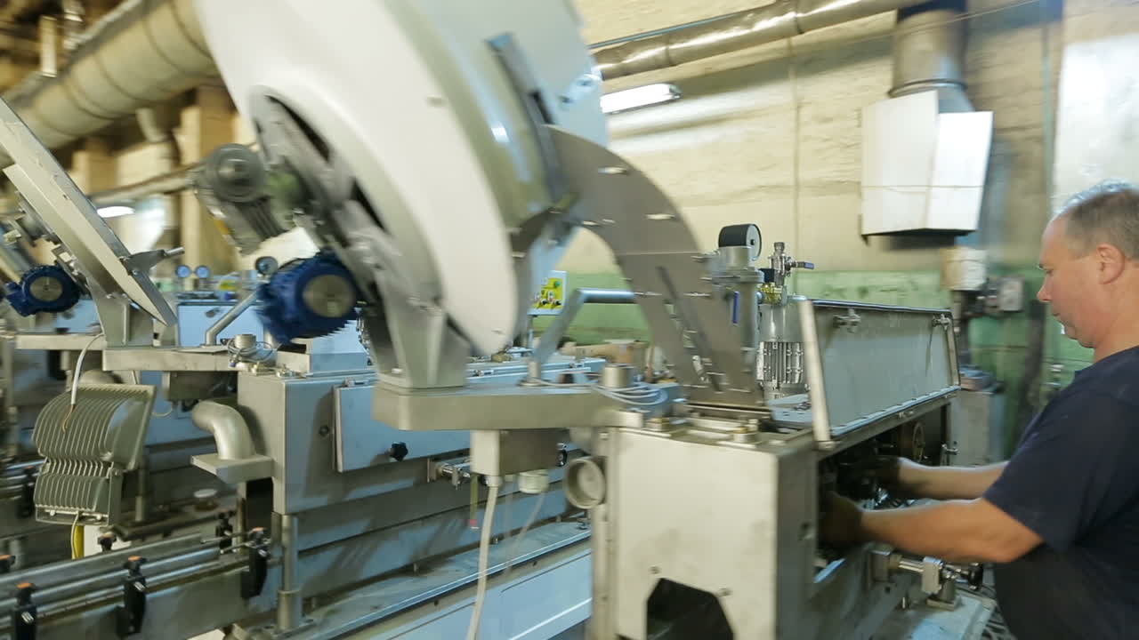 BAR, UKRAINE - AUGUST 2017: Worker in production plant drilling at machine on the factory