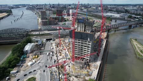 Drone-shot-circling-around-Elbtower-tower-under-construction-site-in-Hamburg-northern-Germany-on-the-banks-of-river-Elbe