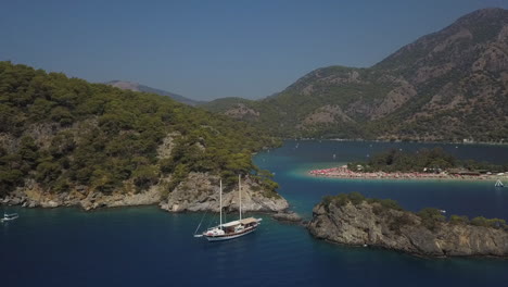 aerial orbits tourist ship in shallow bay in turkish mediterranean