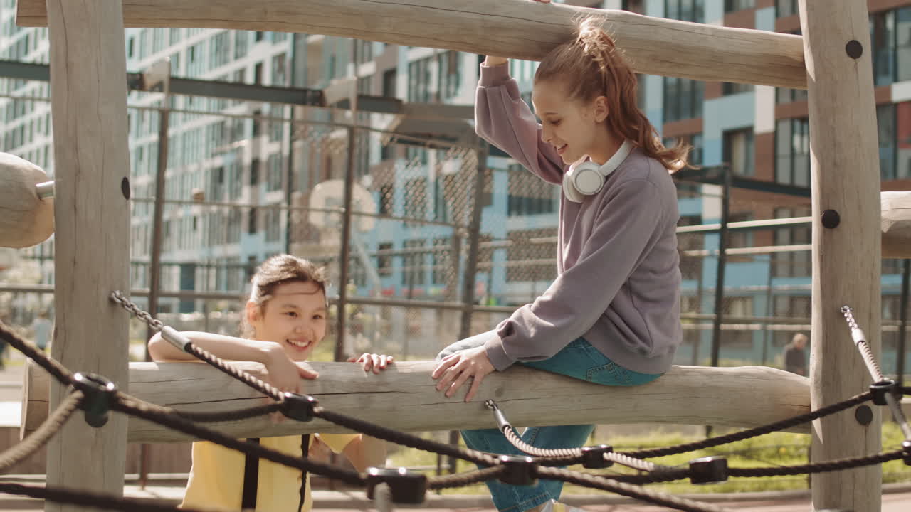 Girls Climbing on Playground at Schoolyard