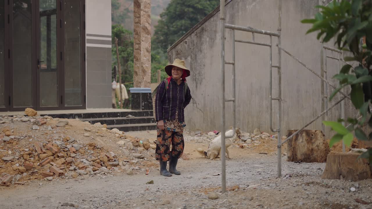 Elderly Woman Working on Construction Site in Village