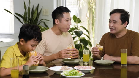 asian men and boy sitting at the table