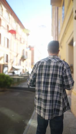 man walking down a city alley