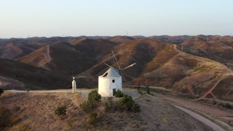 aerial footage of a windmill on a hill