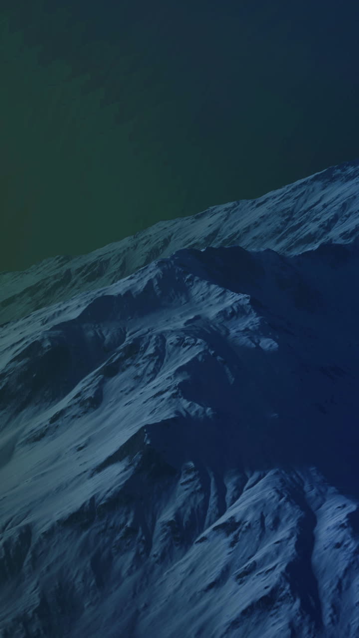 Mountains covered with snow during night under the northern lights