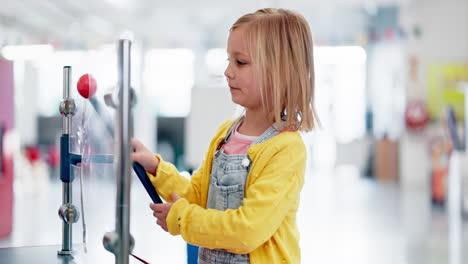 young girl experiencing interactive science exhibit