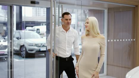 elegant couple came to choose car in dealership