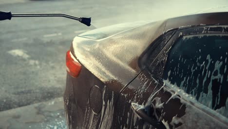 car being pressure washed with foam